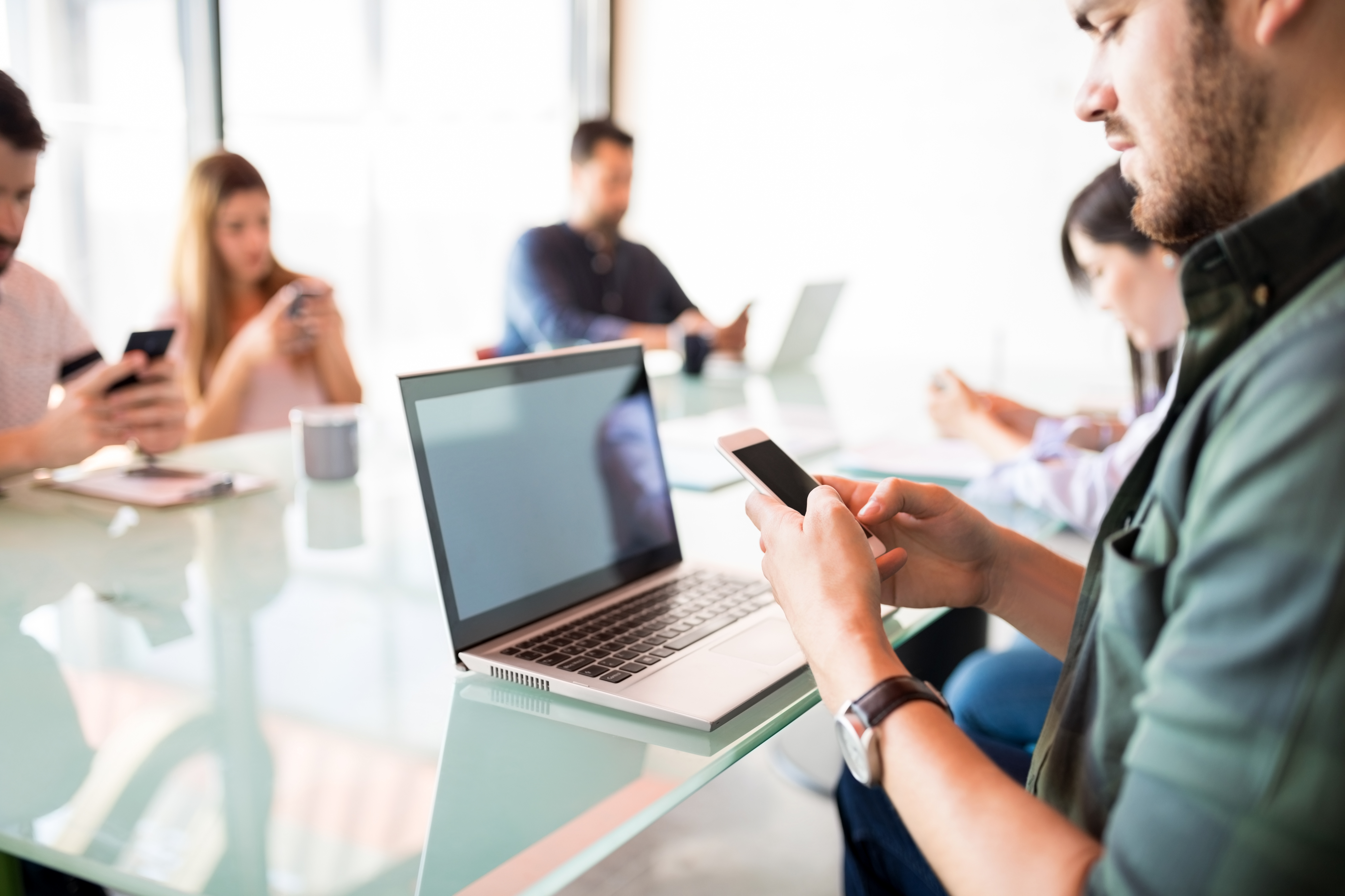 Man with a phone in during meeting break