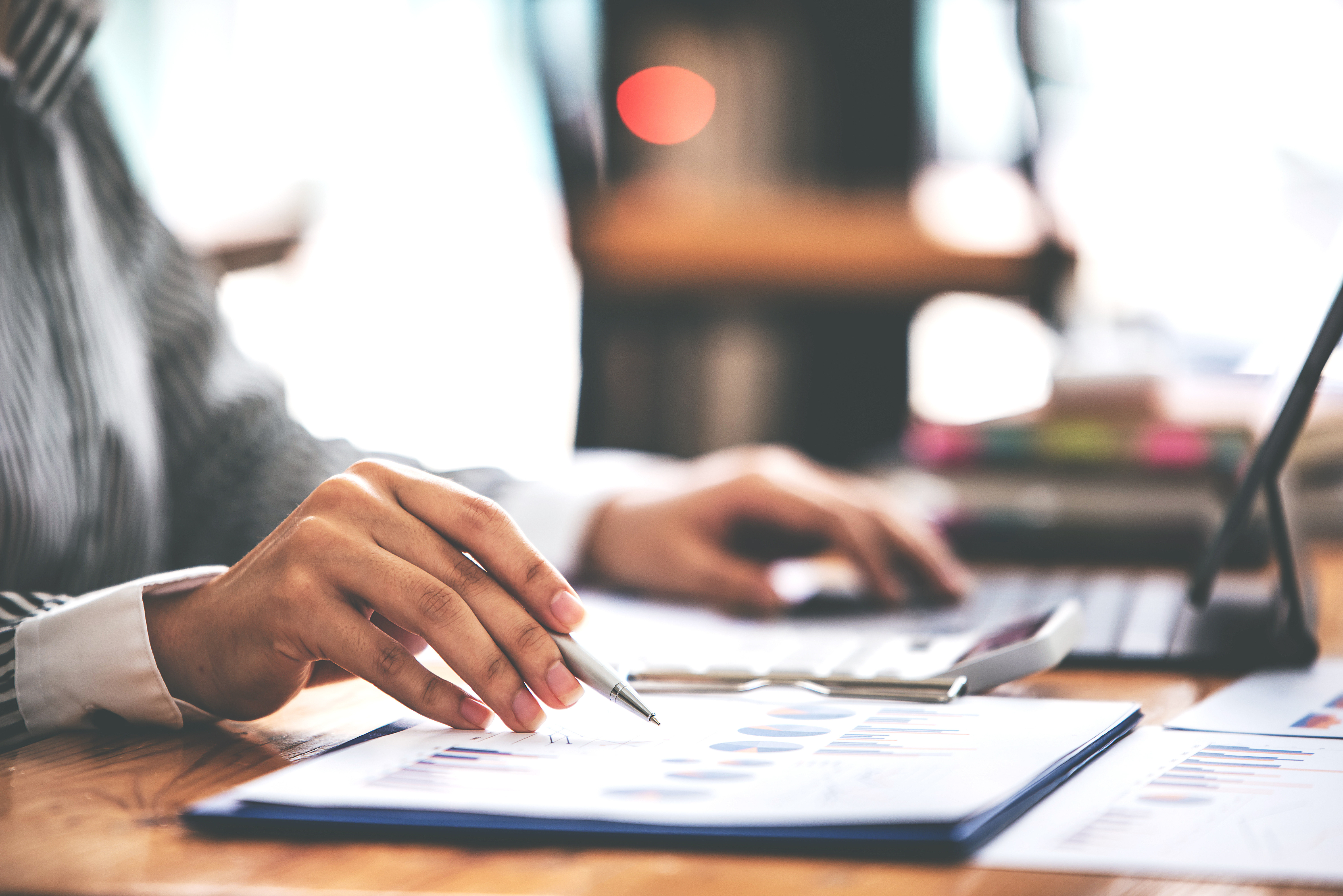 Female hand doing accounting work at desk