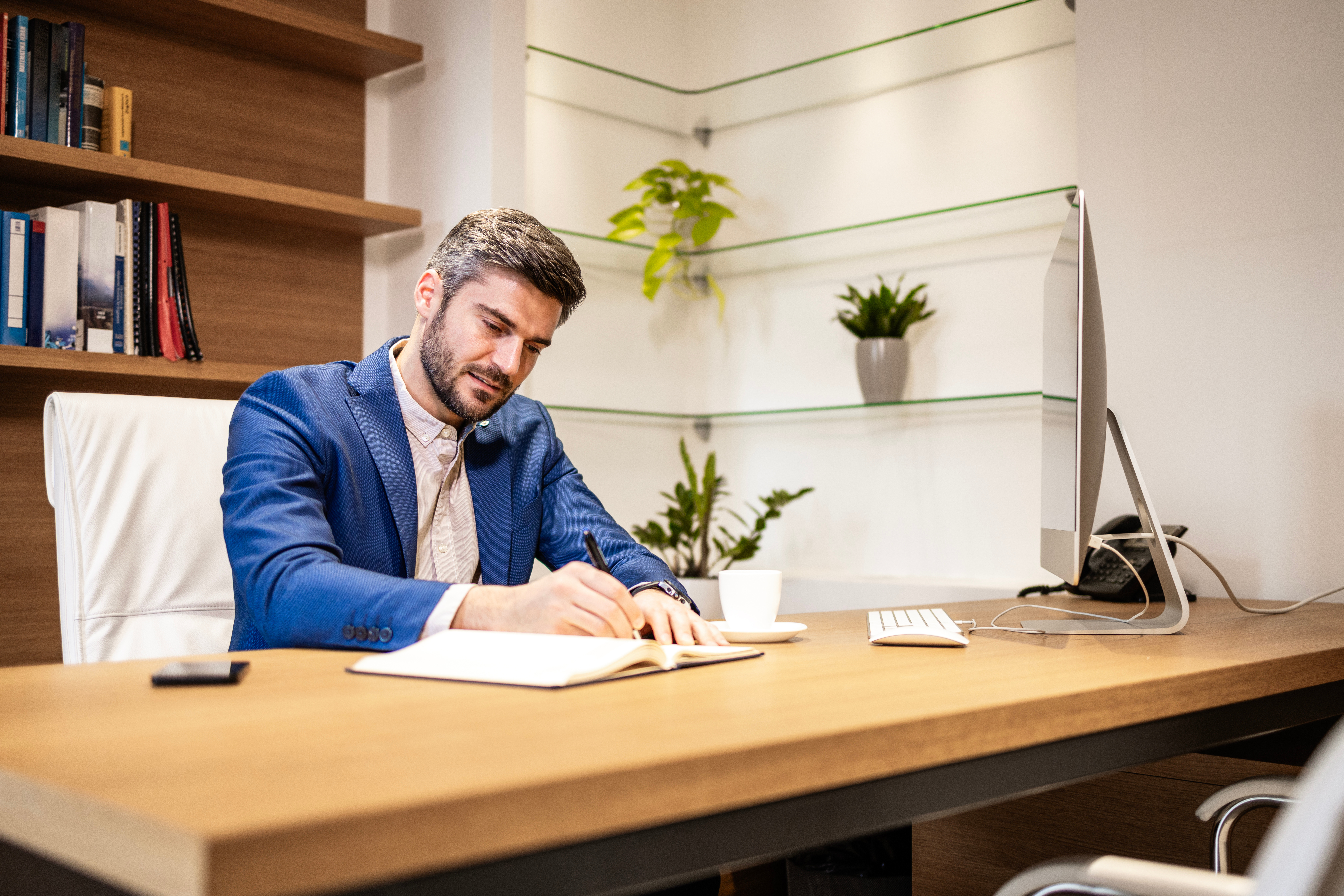 Experienced financial director working in his office and making calculations